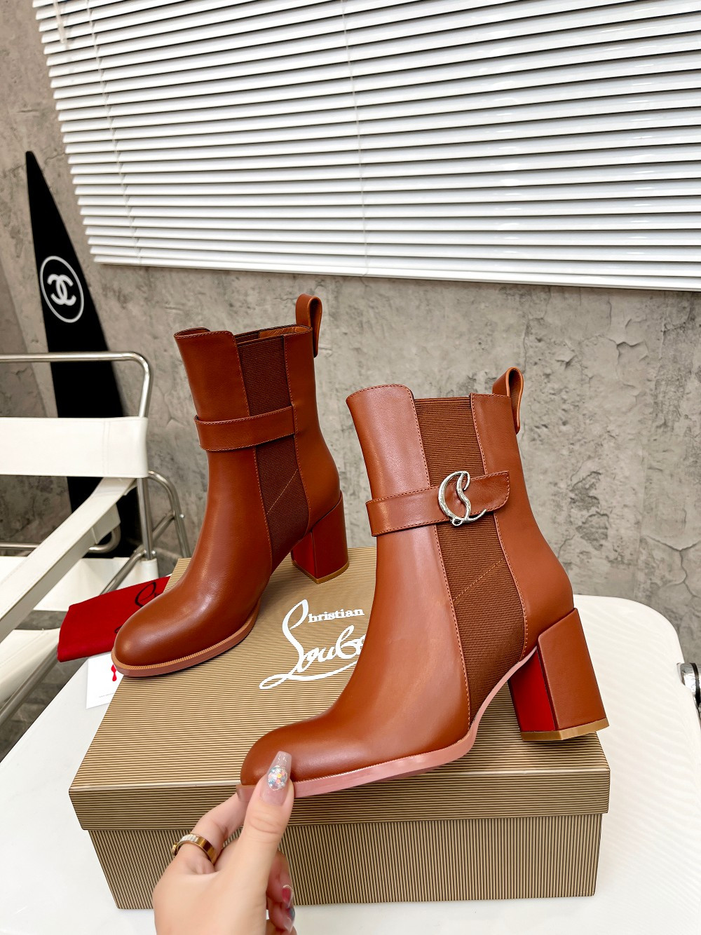 UA Ch**an Louboutin (CL) launched a new collection of chunky heeled platform boots